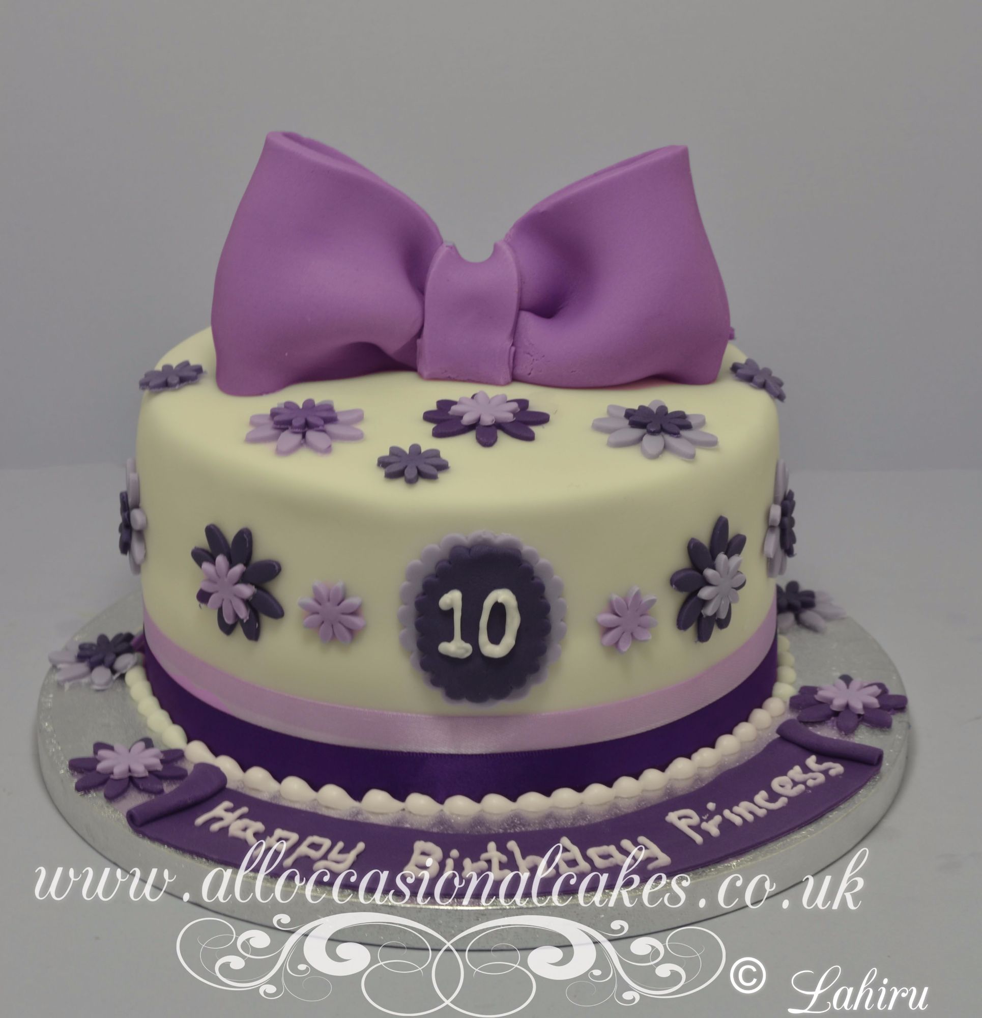 lilac bow with flower petals birthday cake