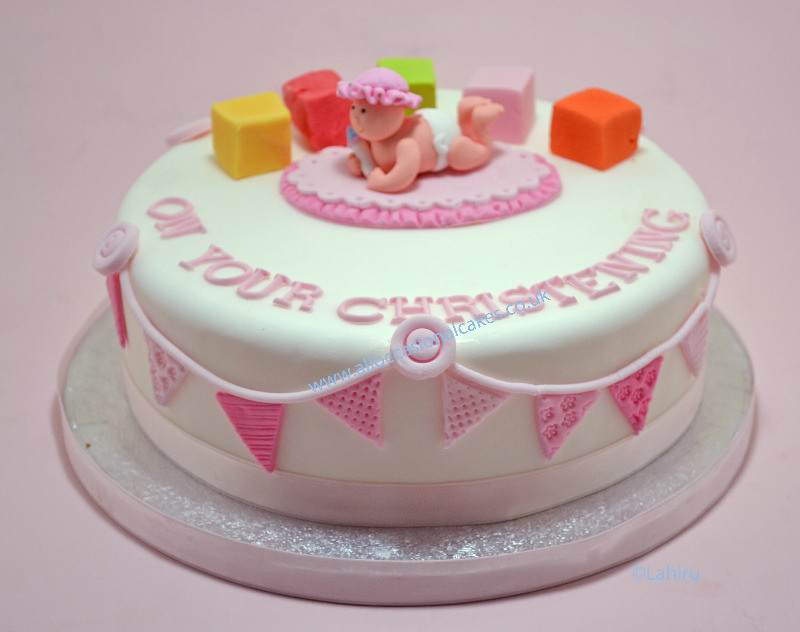 baby girl with blocks christening cake