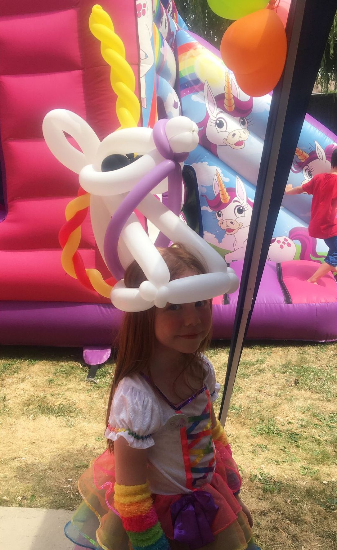 girl wearing unicorn balloon