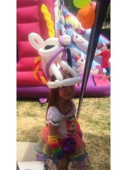 girl wearing unicorn balloon