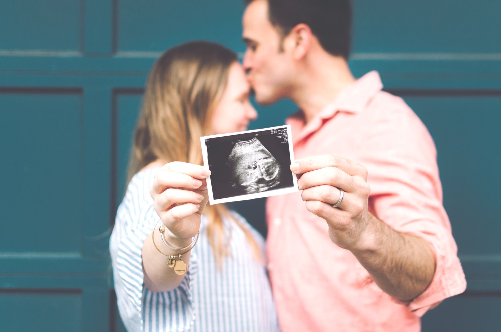 Expecting Couple holding Scan Photo