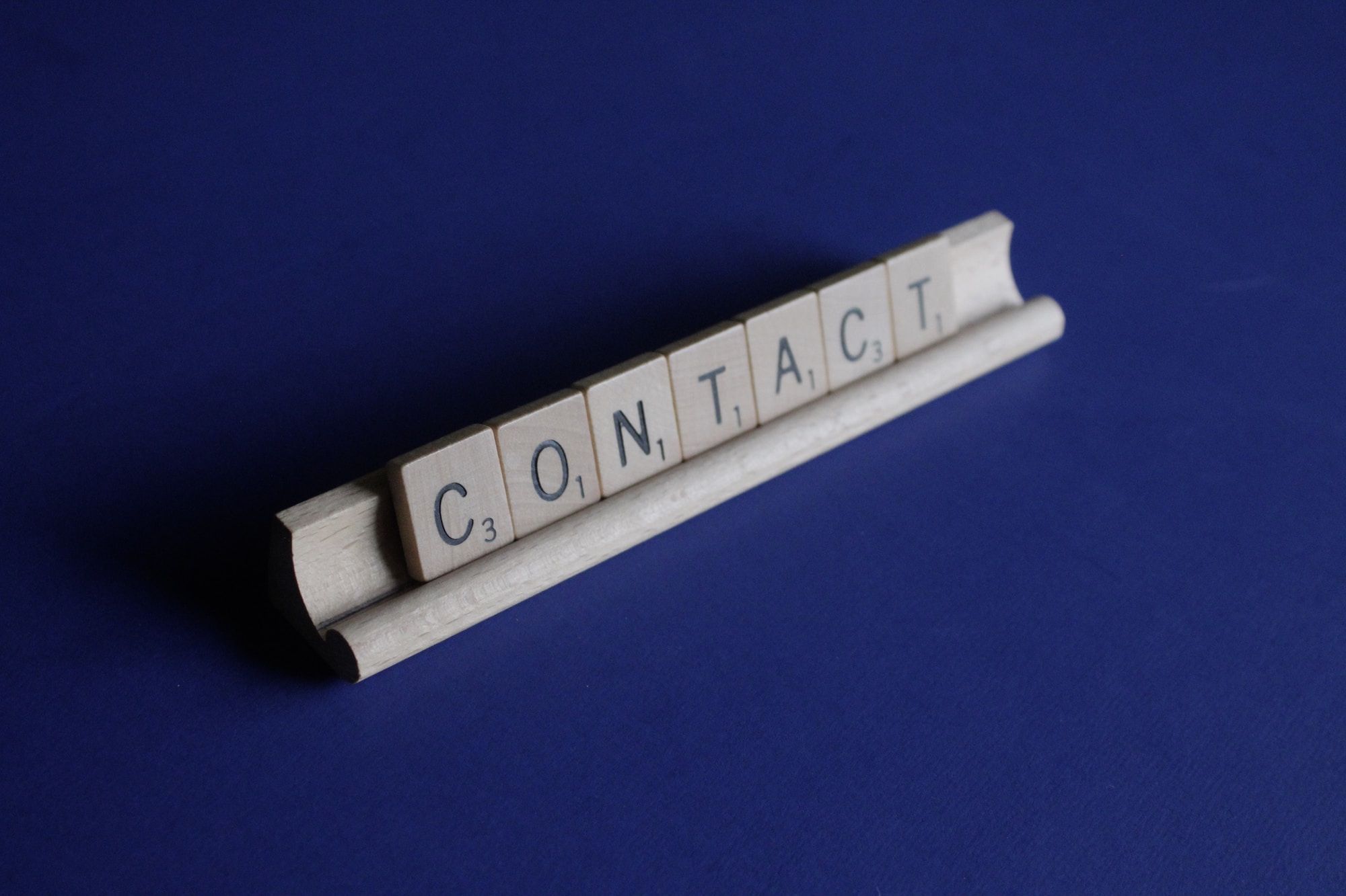 Wooden blocks making up the word contact