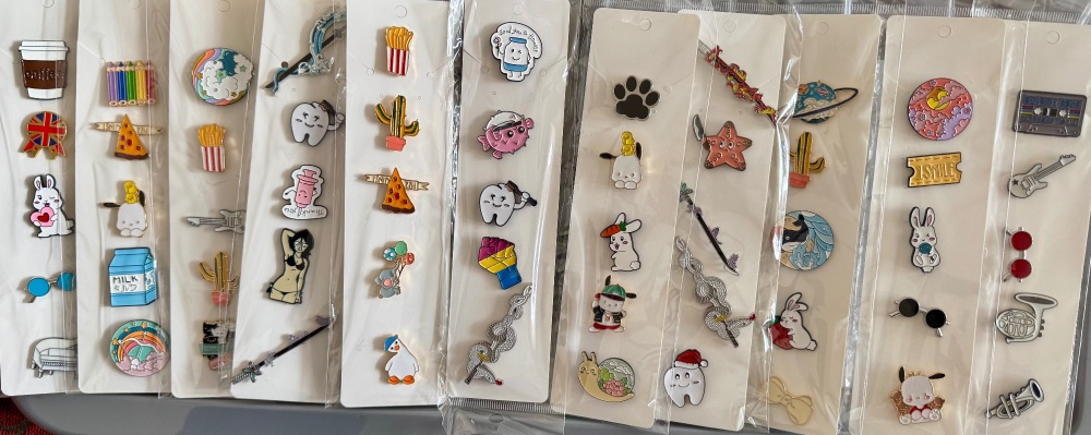 Job lot if 55 pin badges on cards