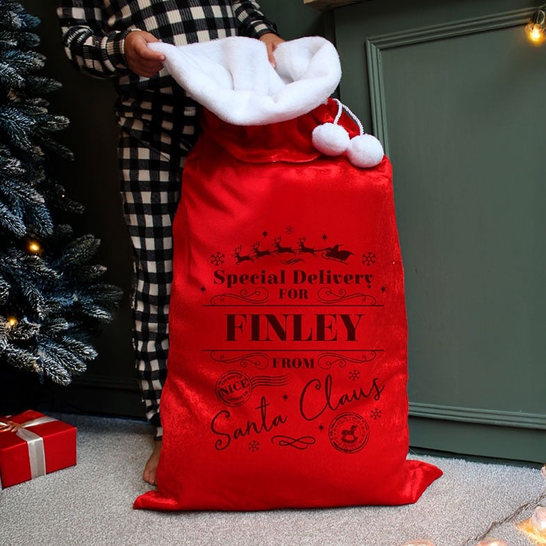 Personalised Red Special Delivery Christmas Sack | plush velvety fabric with fluffy white pompoms, personalised with your name