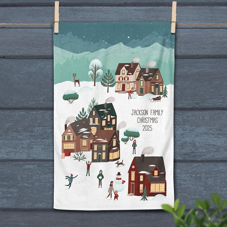 Personalised cotton Christmas tea towel with colourful festive village snow scene hand-drawn illustrations
