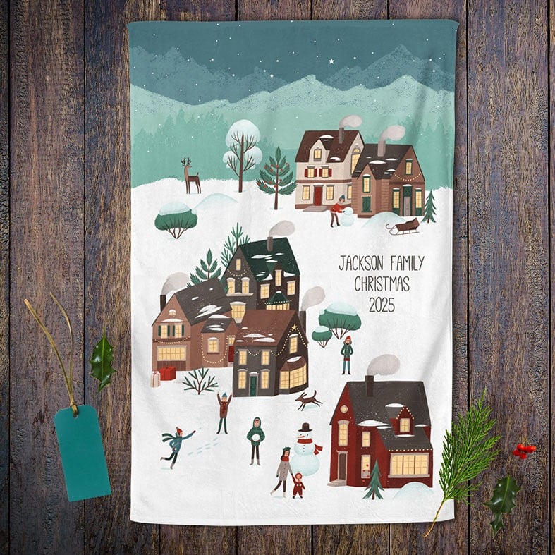 Personalised cotton Christmas tea towel with colourful festive village snow scene hand-drawn illustrations