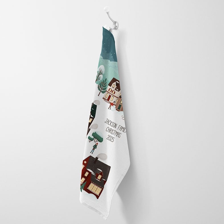 Personalised cotton Christmas tea towel with colourful festive village snow scene hand-drawn illustrations