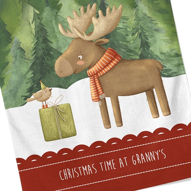 Personalised cotton Christmas tea towel in dark green and red with snowy friendly reindeer illustration