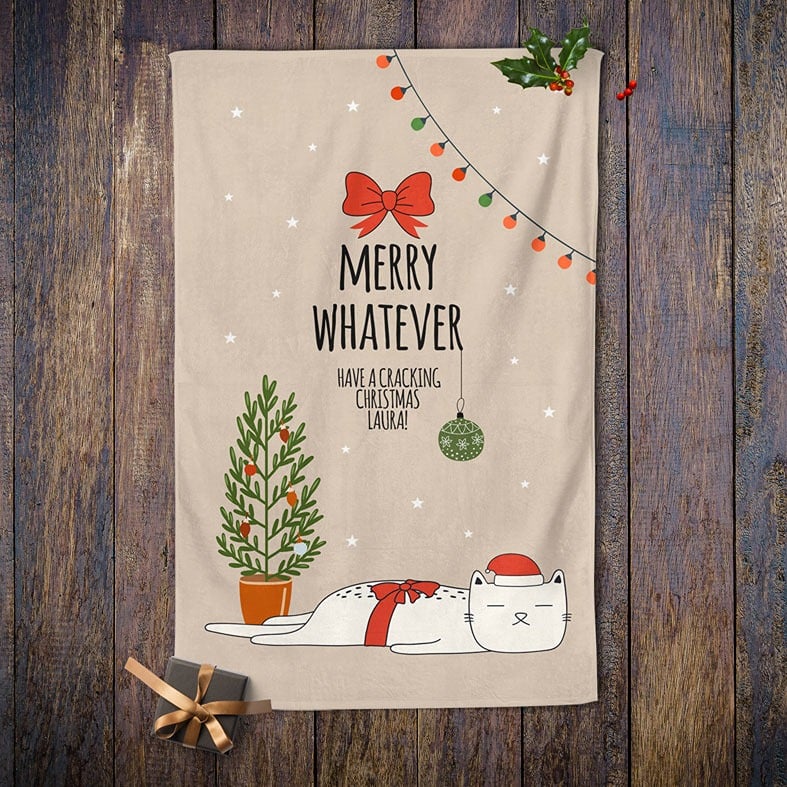 Personalised Christmas tea towel in white or beige with funny sleepy cat illustration and Merry Whatever wording