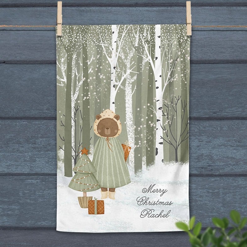 Personalised cotton Christmas tea towel in sage green and white with snowy hand-drawn festive illustration