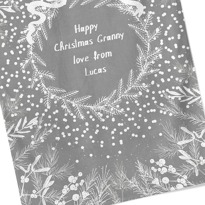 Personalised cotton Christmas tea towel in pale grey and white with white winter wreath, leaves, and berries
