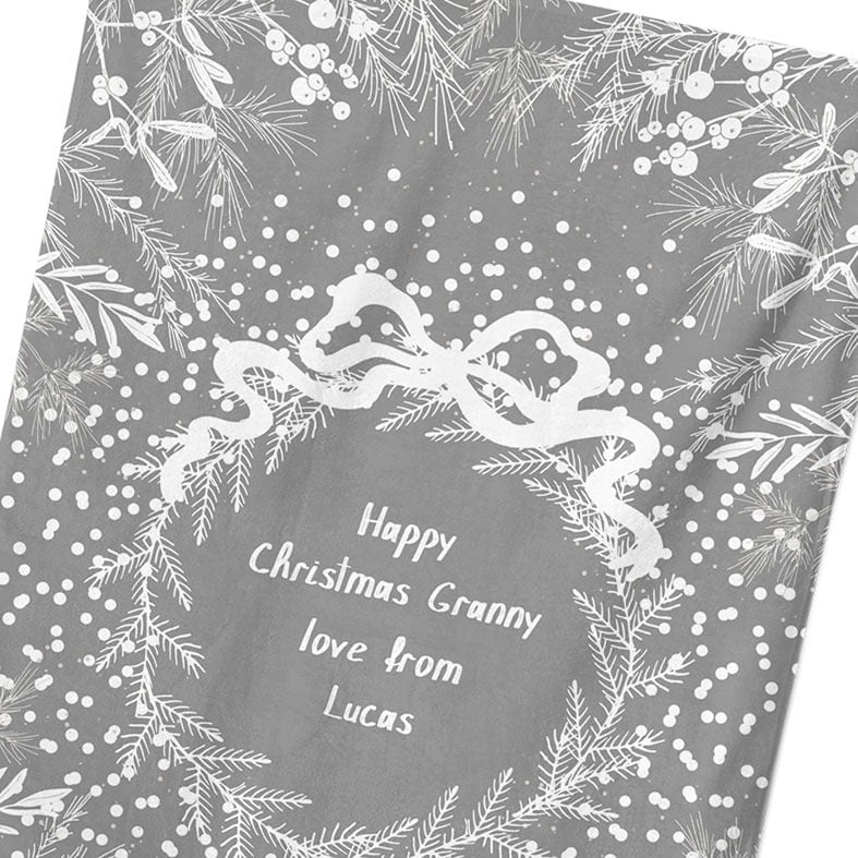 Personalised cotton Christmas tea towel in pale grey and white with white winter wreath, leaves, and berries