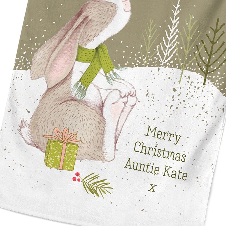 Personalised cotton Christmas tea towel in sage green with snowy scene and sweet winter rabbit illustration
