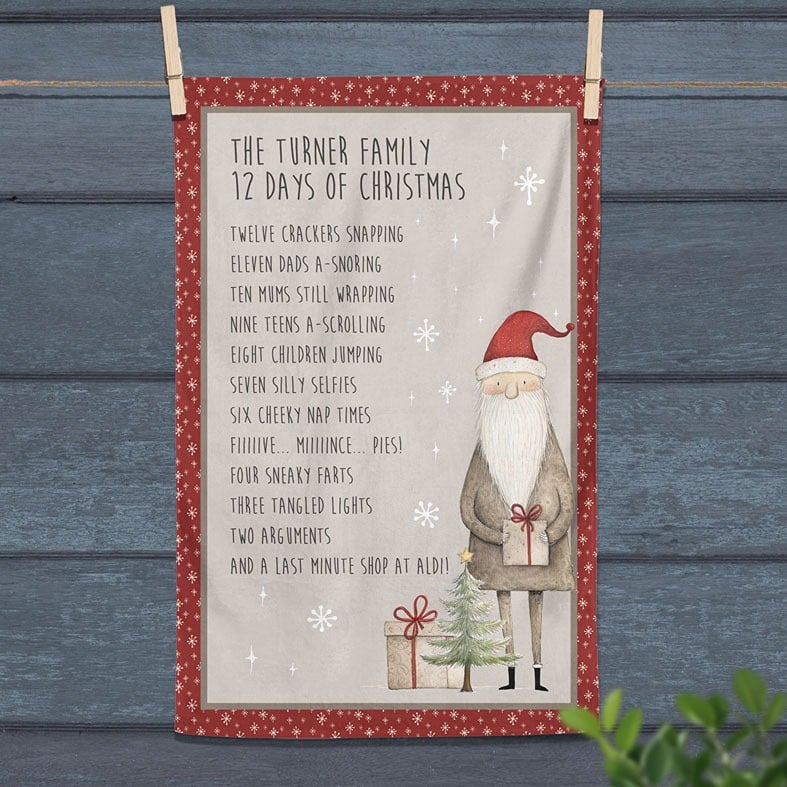 Personalised cotton Christmas tea towel in red and beige with a Santa illustration and funny rewording of 12 Days of Christmas