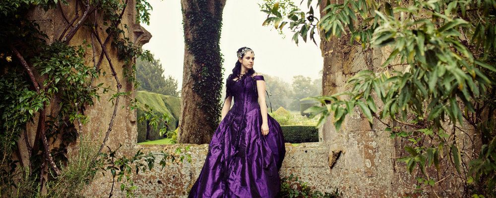 Purple wedding and bridal dress worn by the bride at Sudely castle in Winchcombe UK. Hair styled by sheenasweddinghairstyles.co.uk