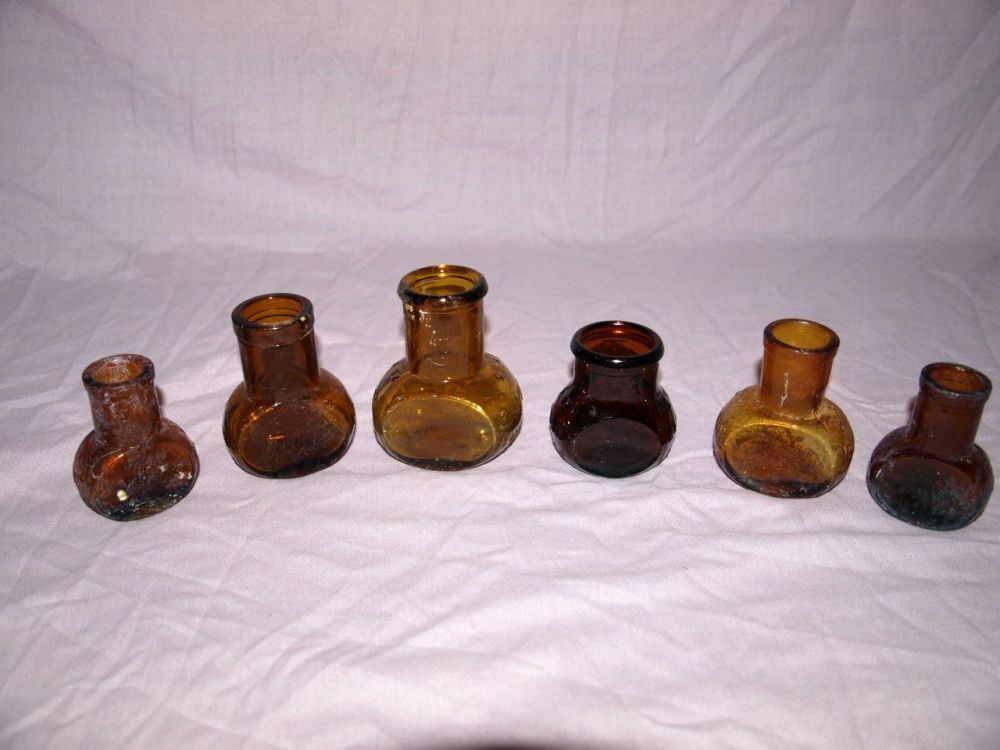 Antique Amber Glass Bovril Jars .