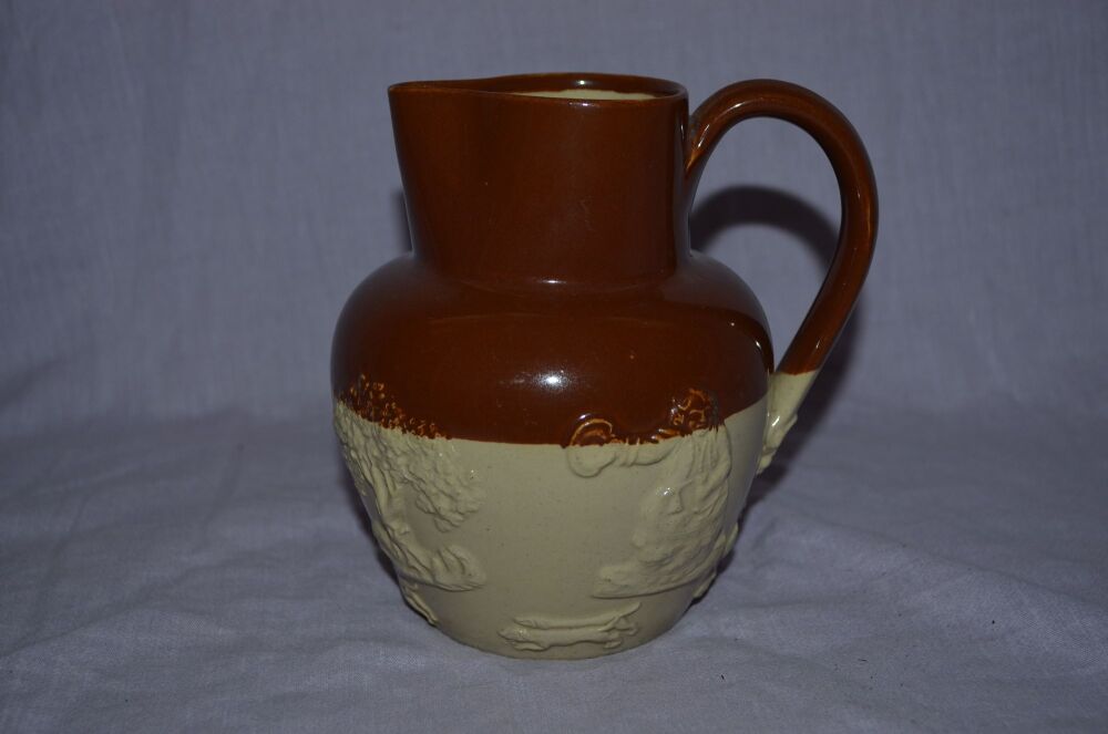 Brown Glazed Fox Hunting Jug.