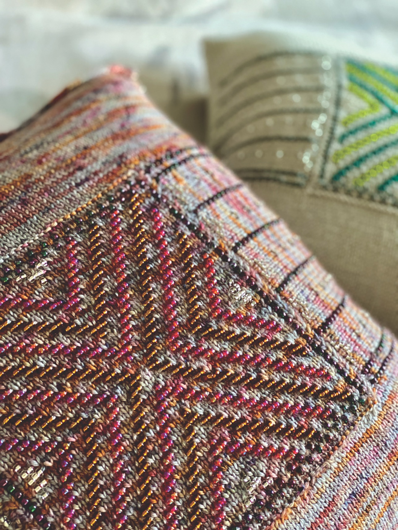 Close up of Solace cushion with beds knitted in