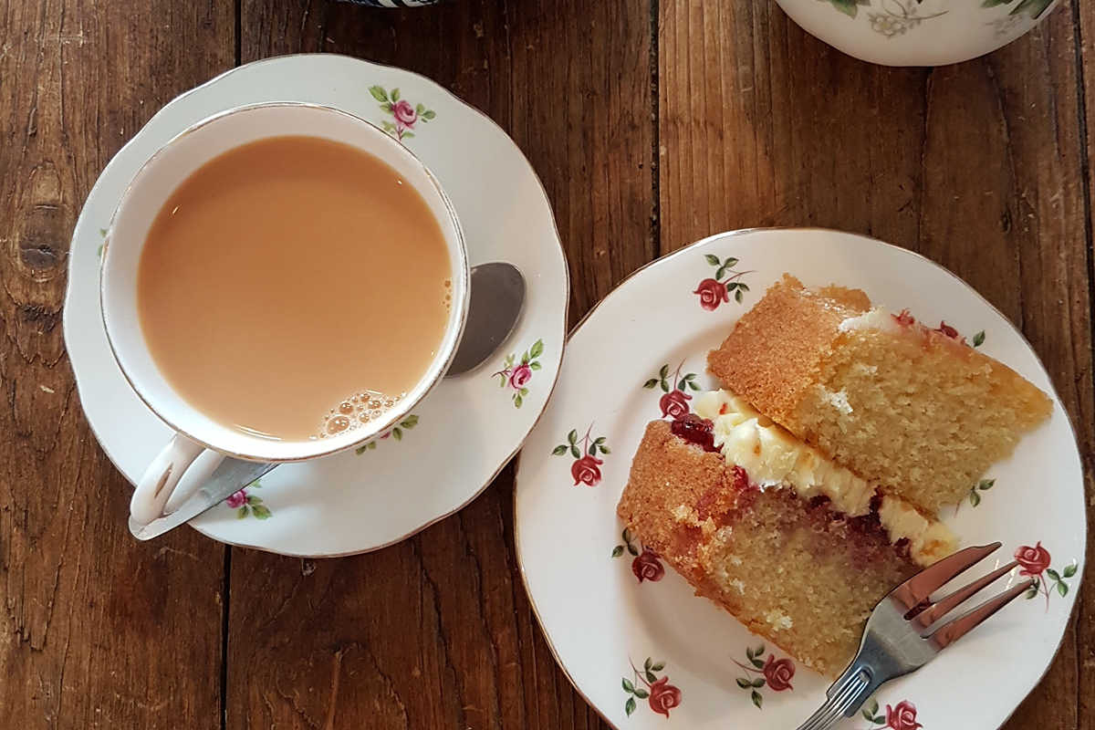 Homemade victoria sponge with a cup of tea