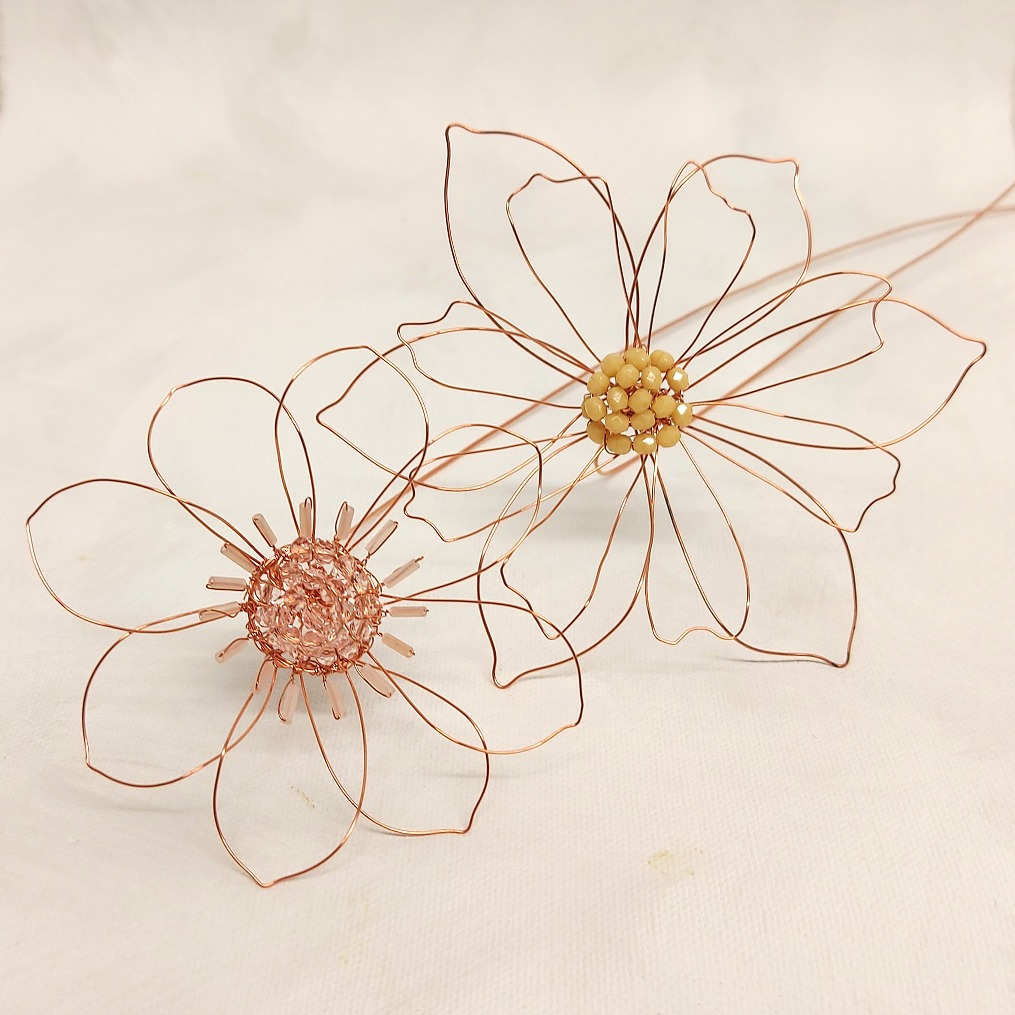 Close up of copper wire flowers with beaded details