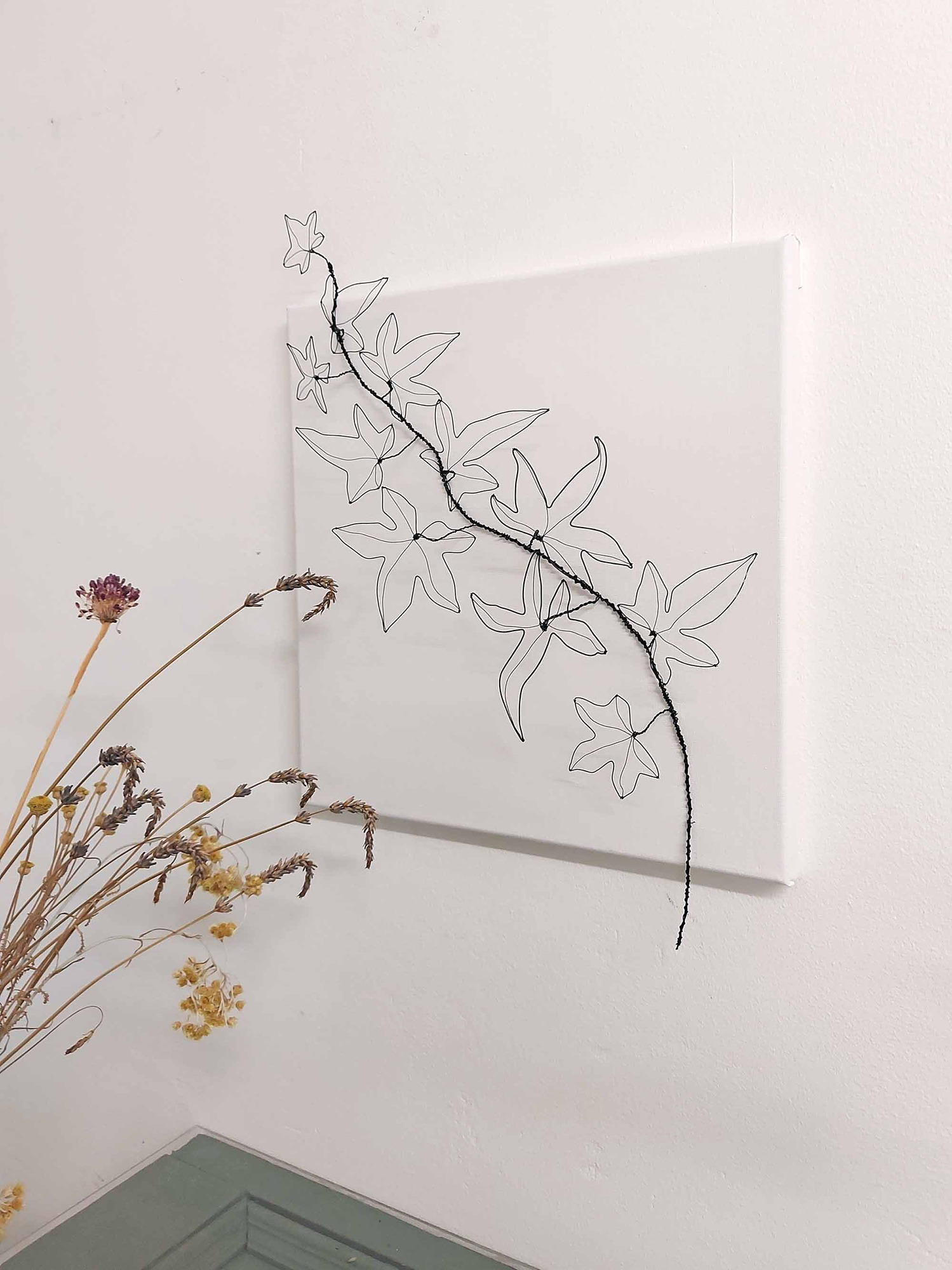 A camnase with handmade wire ivy leaves