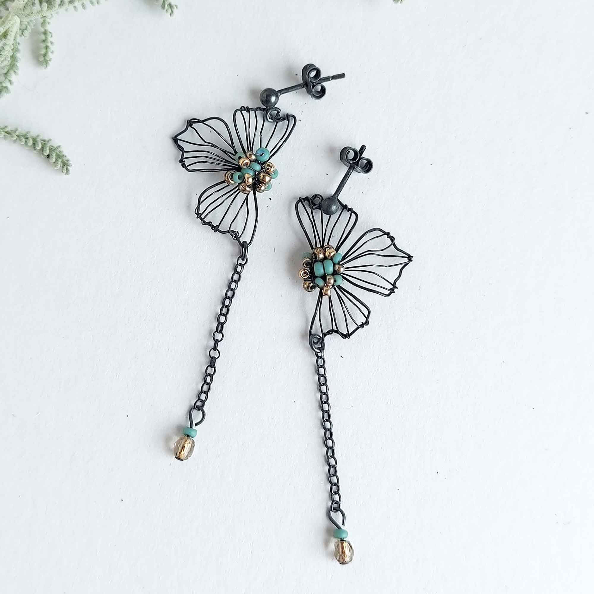 Handmade silver wire flower drop earrings with green beading