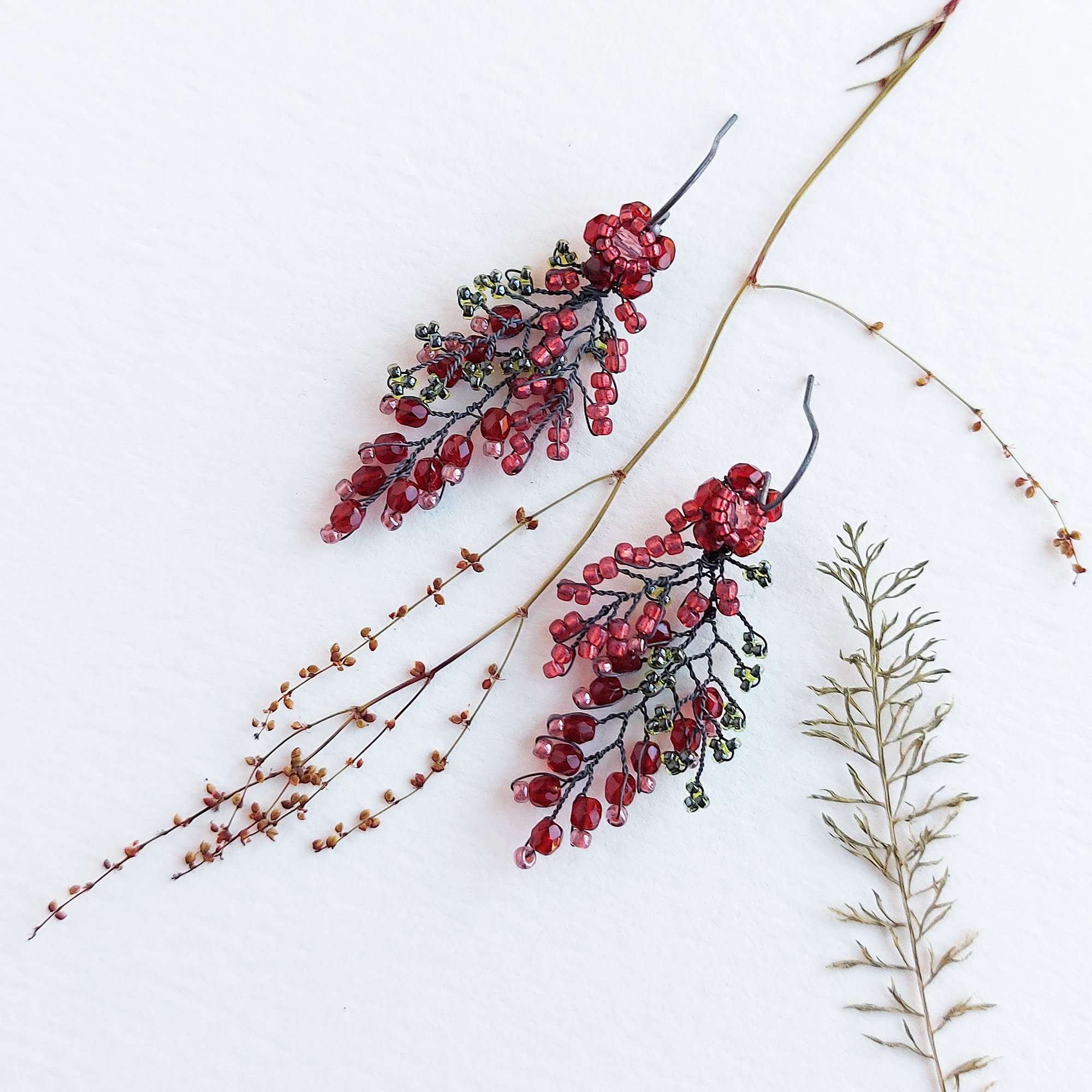Hand beaded silver leaf earrings in red by Judith Brown