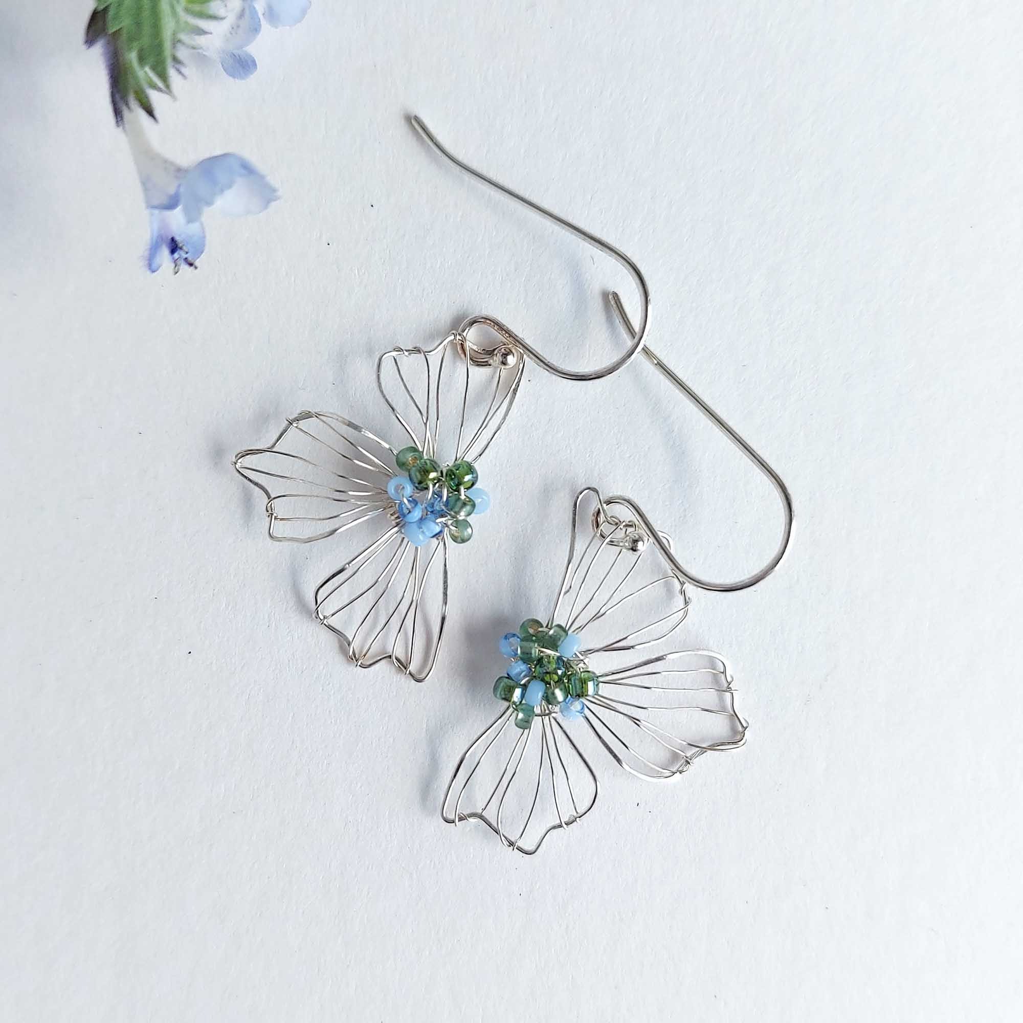 Silver flower earrings with blue and green beads