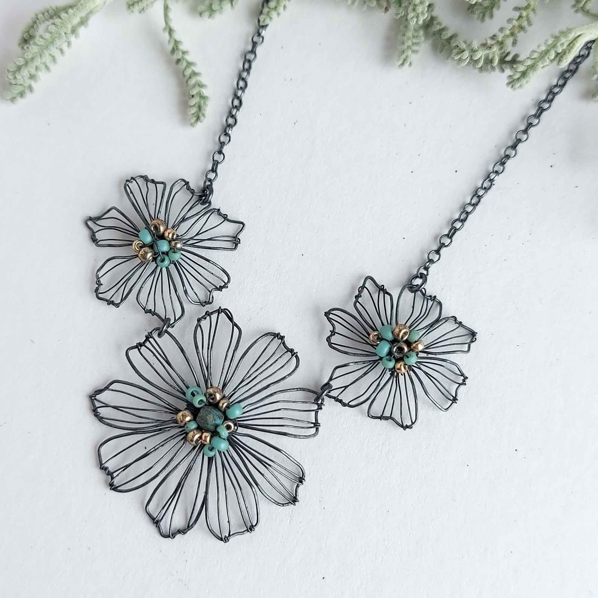 Art deco inspired geometric triangle necklace and earrings in green and gold by Judith Brown