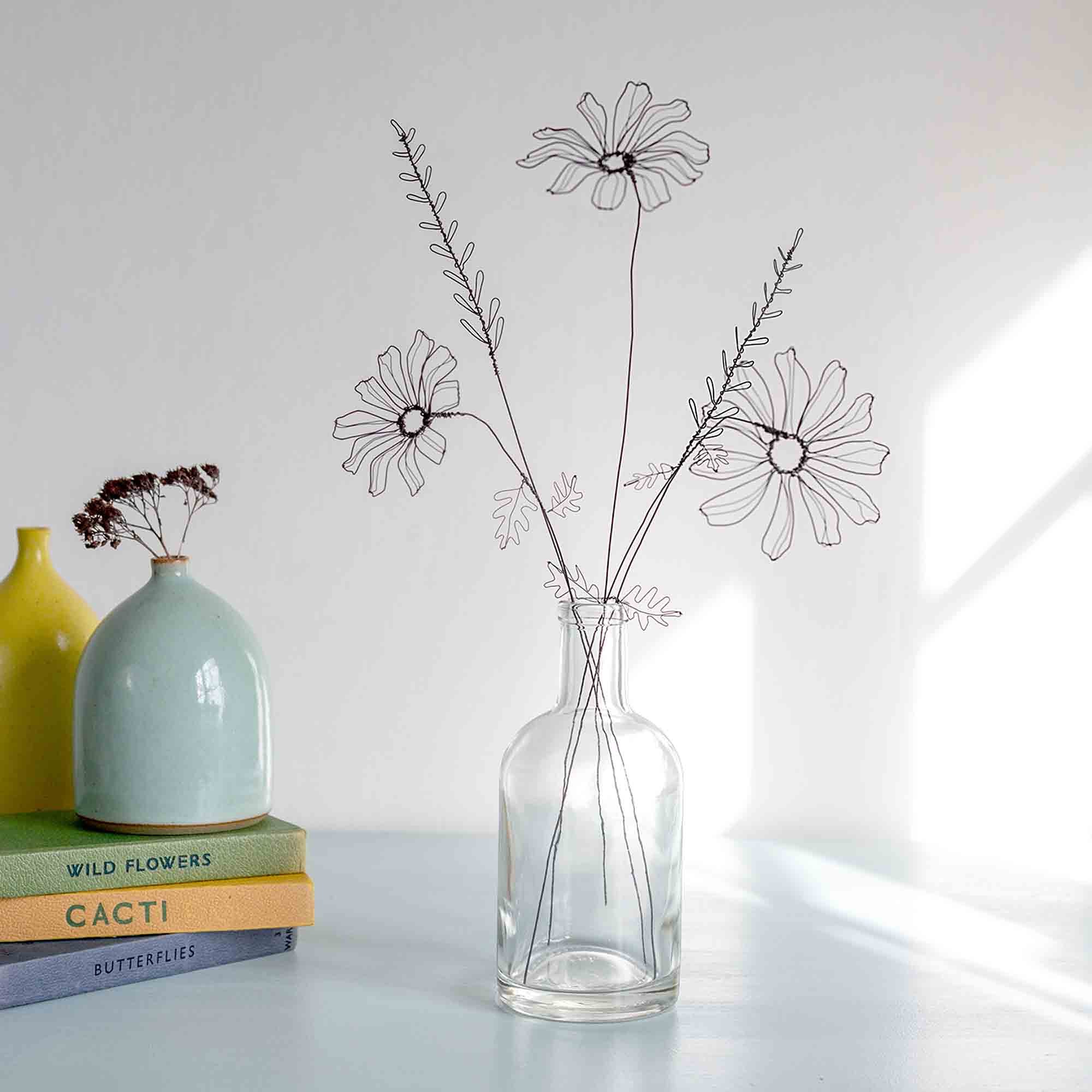 Wire flower gift in a glass bottle by Judith Brown