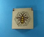 Laser-engraved and laser-cut hinged box with bee motif
