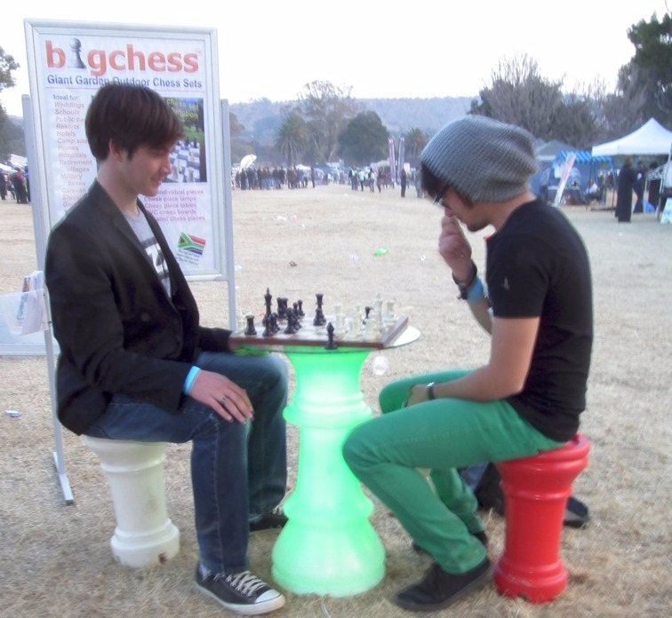 "Small" Chess players at a green queen table