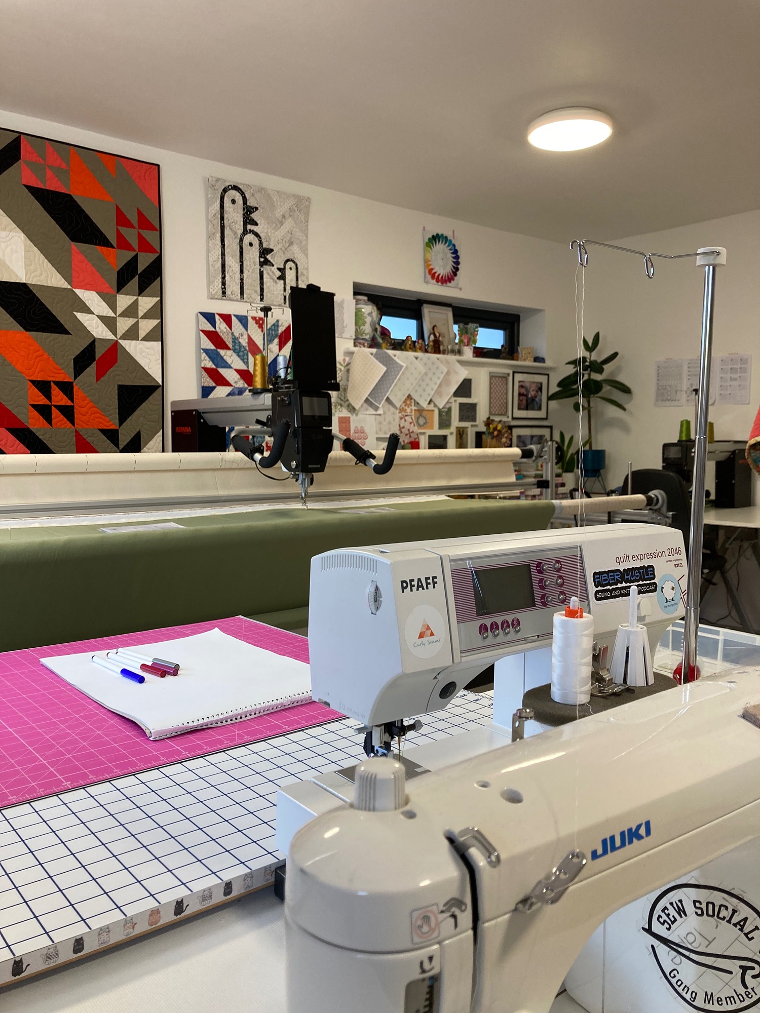 image of a longarm quilting machine and a omestic sewing machine