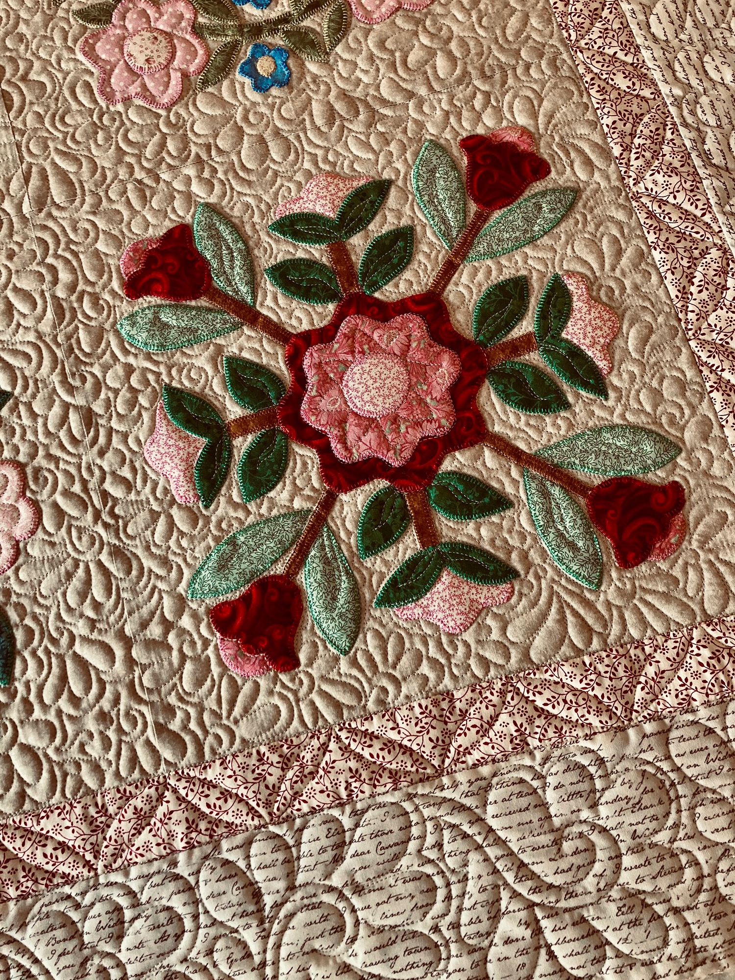 image of a traditional applique quilt quilted with freehand  feathers