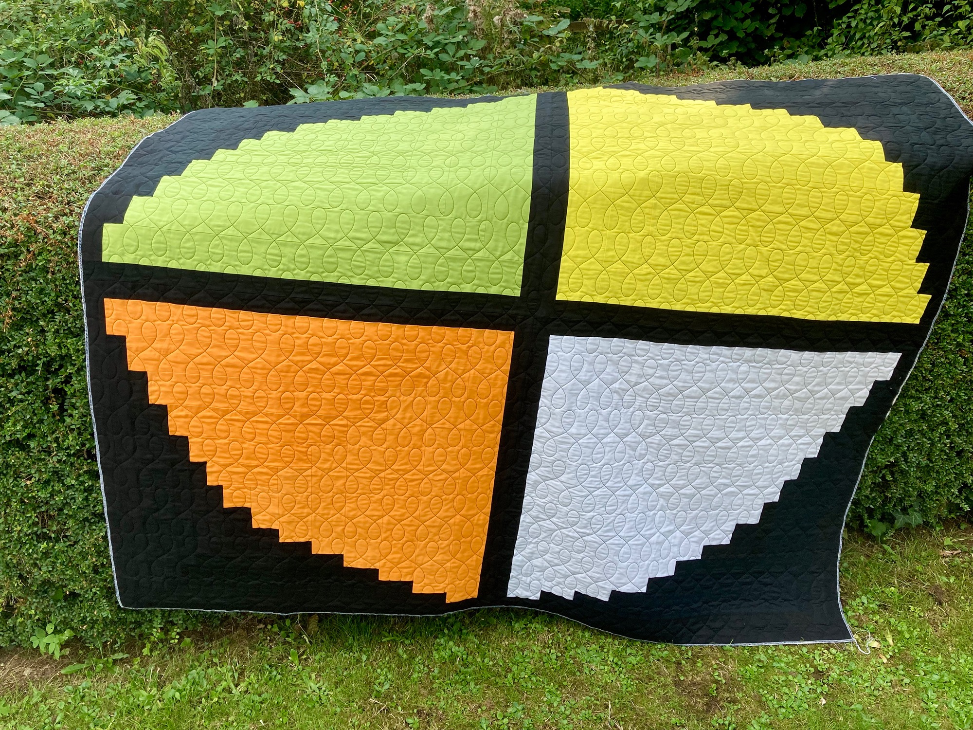 Image of a log cabin quilt stitched with a figure design