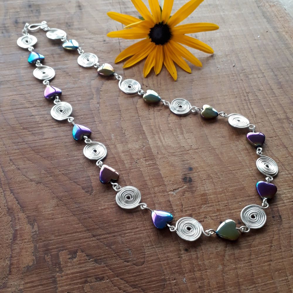 Rainbow Hematite hearts and closed spirals necklace