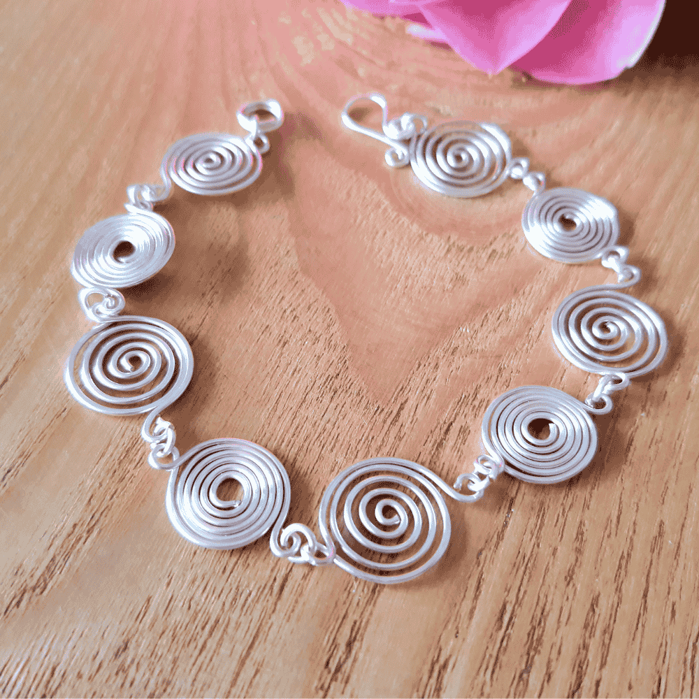 5 Open and Closed silver spirals bracelet