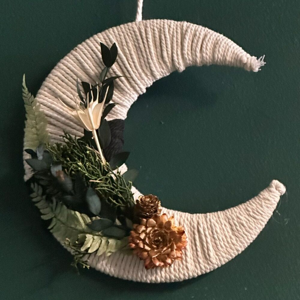 White hanging moon with dried wildflowers