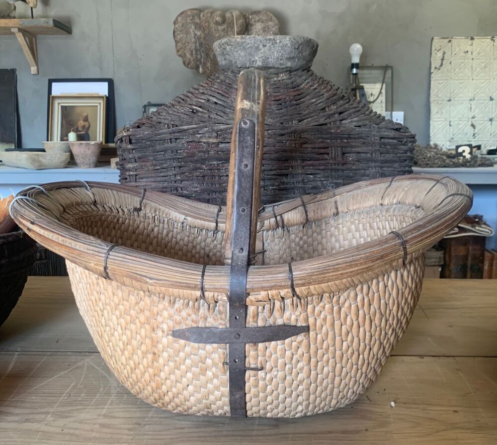 Antique woven basket with bamboo handle