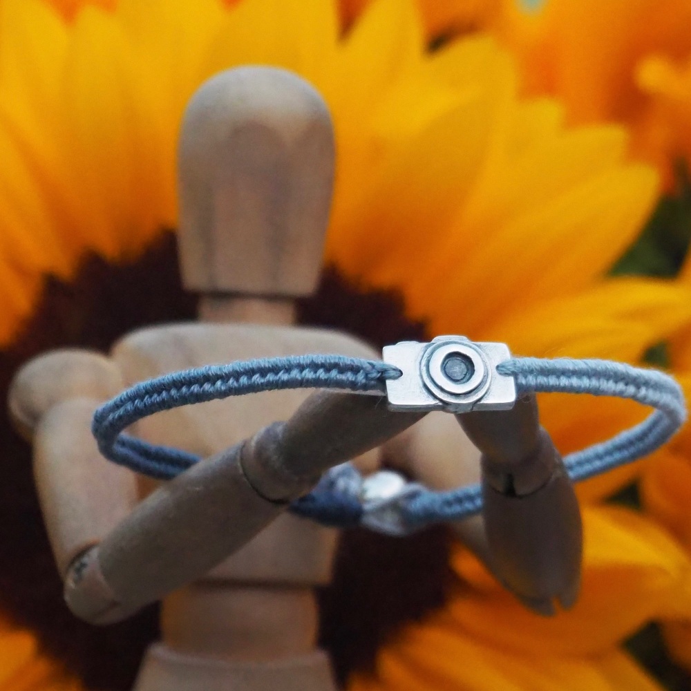 Fine silver classic camera charm on a grey blue friendship bracelet