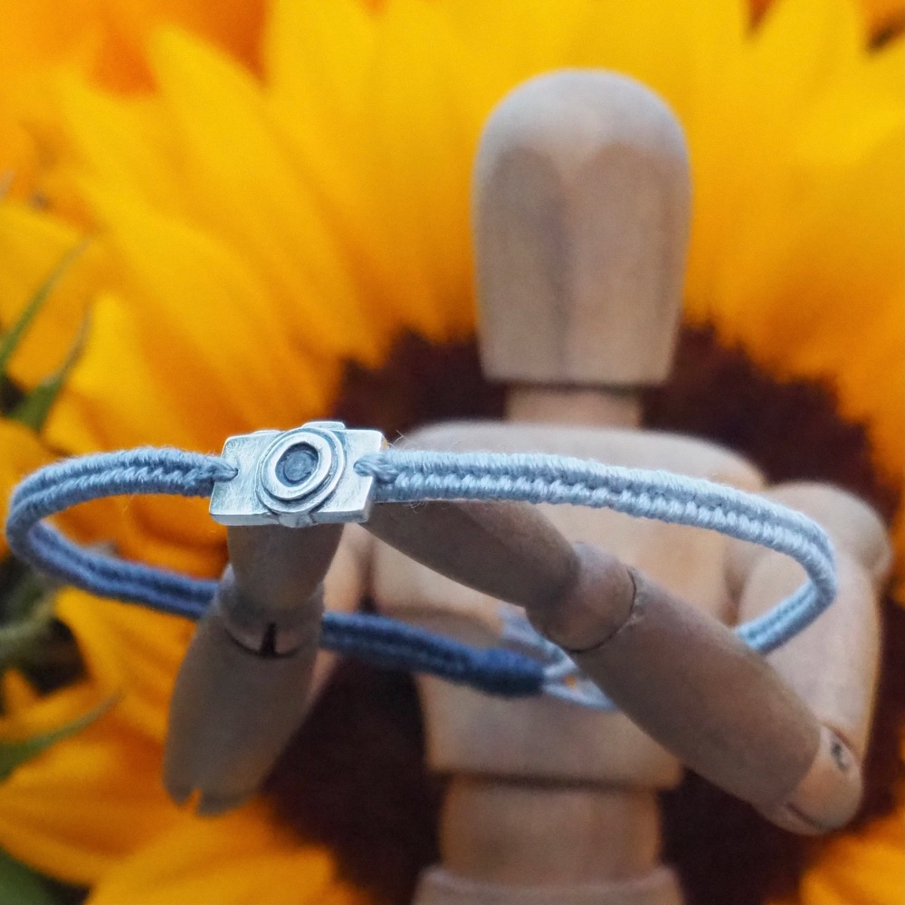 Fine silver classic camera charm on a grey blue friendship bracelet