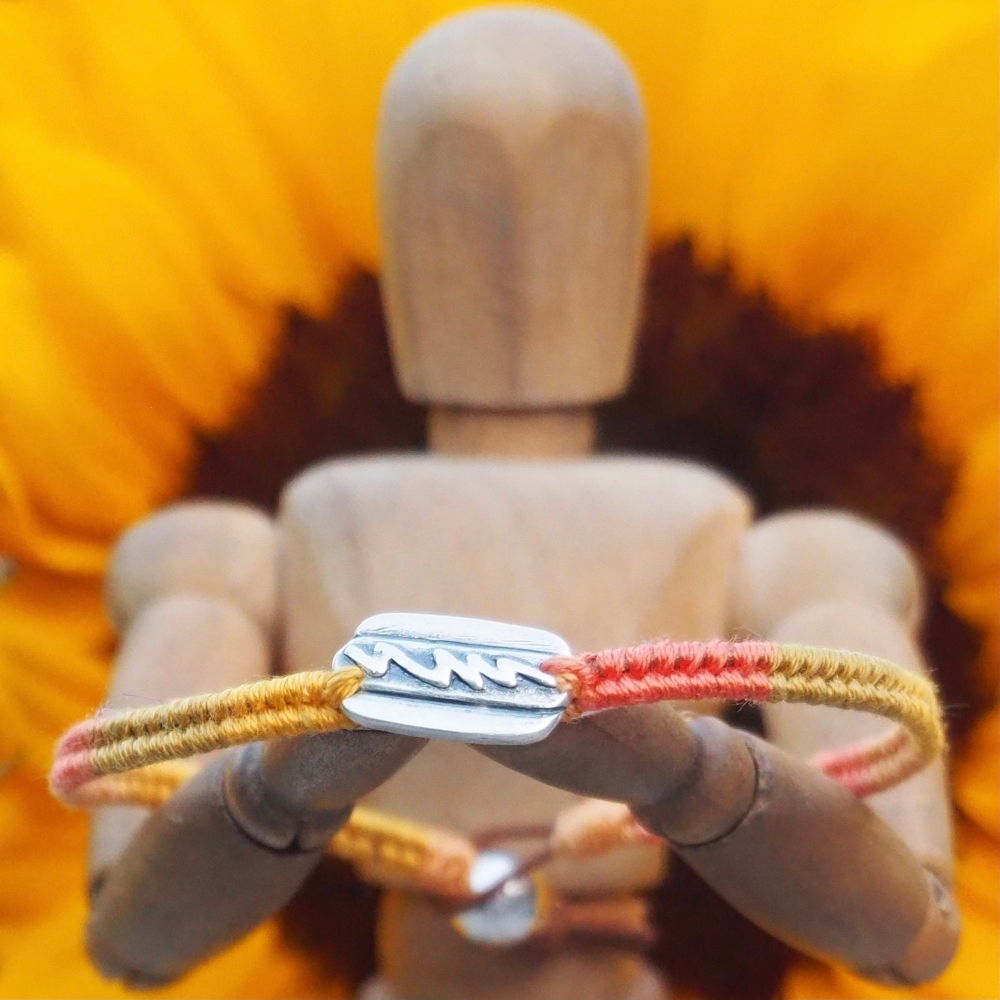 Fine silver hot dog charm on a mustard orange friendship bracelet