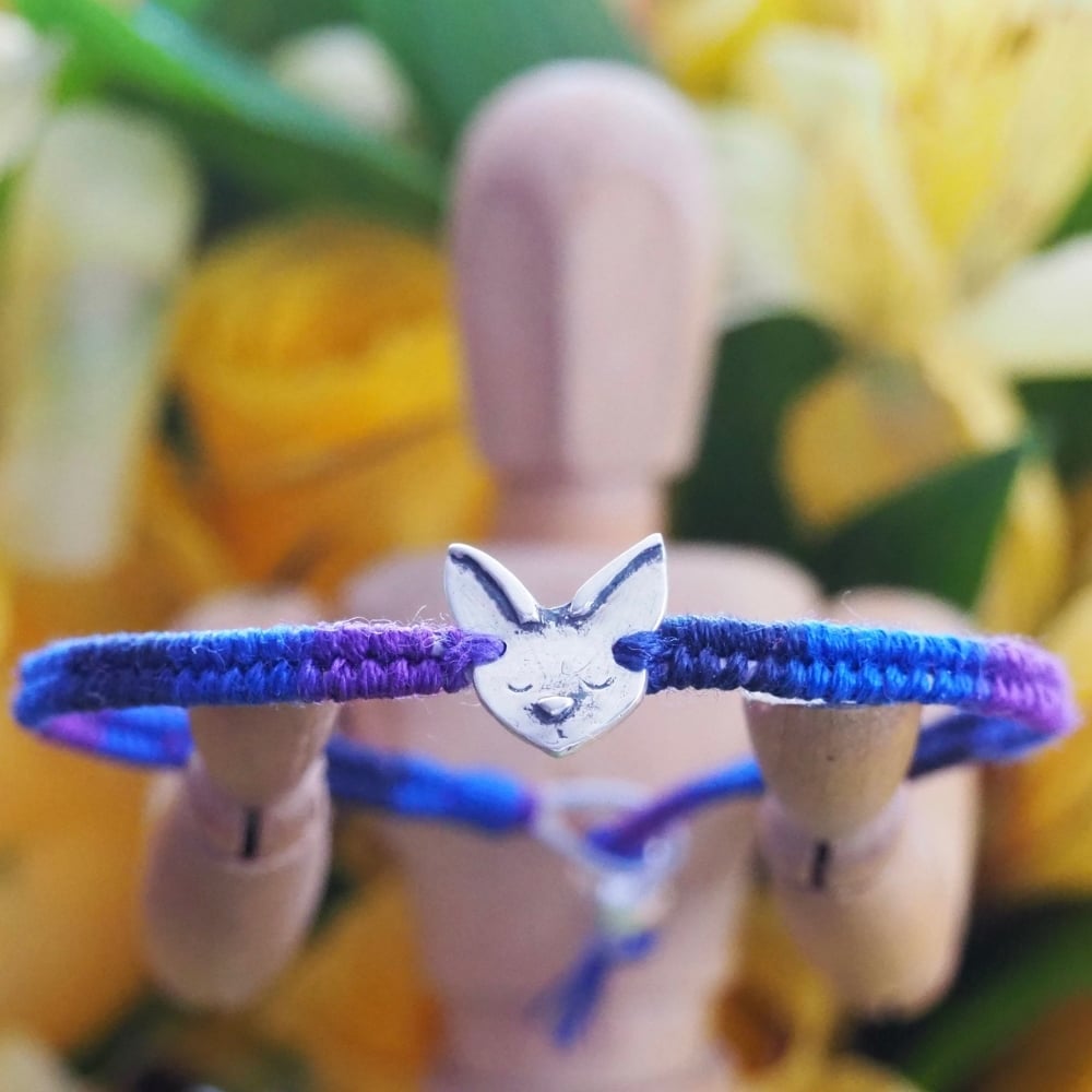 Fine silver Siamese cat charm on a deep blue friendship bracelet