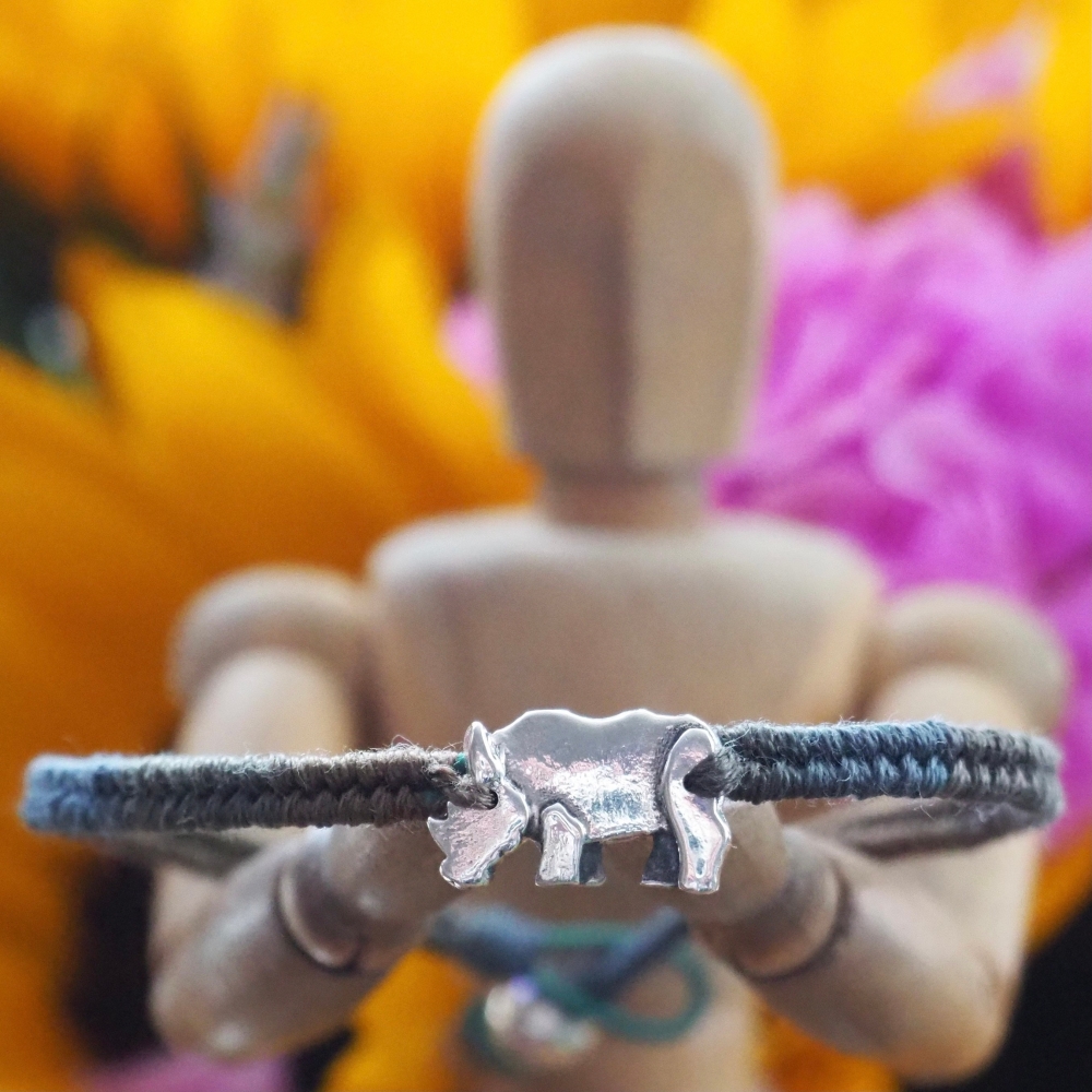 Fine silver rhino charm on a brown friendship bracelet