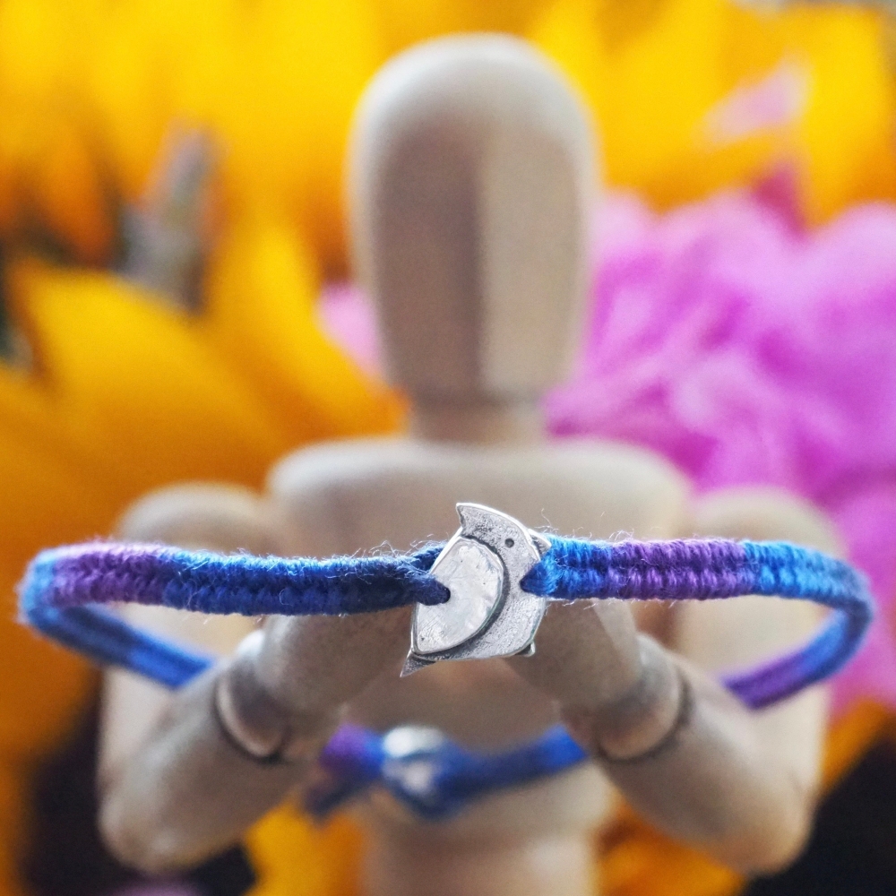 Fine silver jay bird charm on a blue friendship bracelet