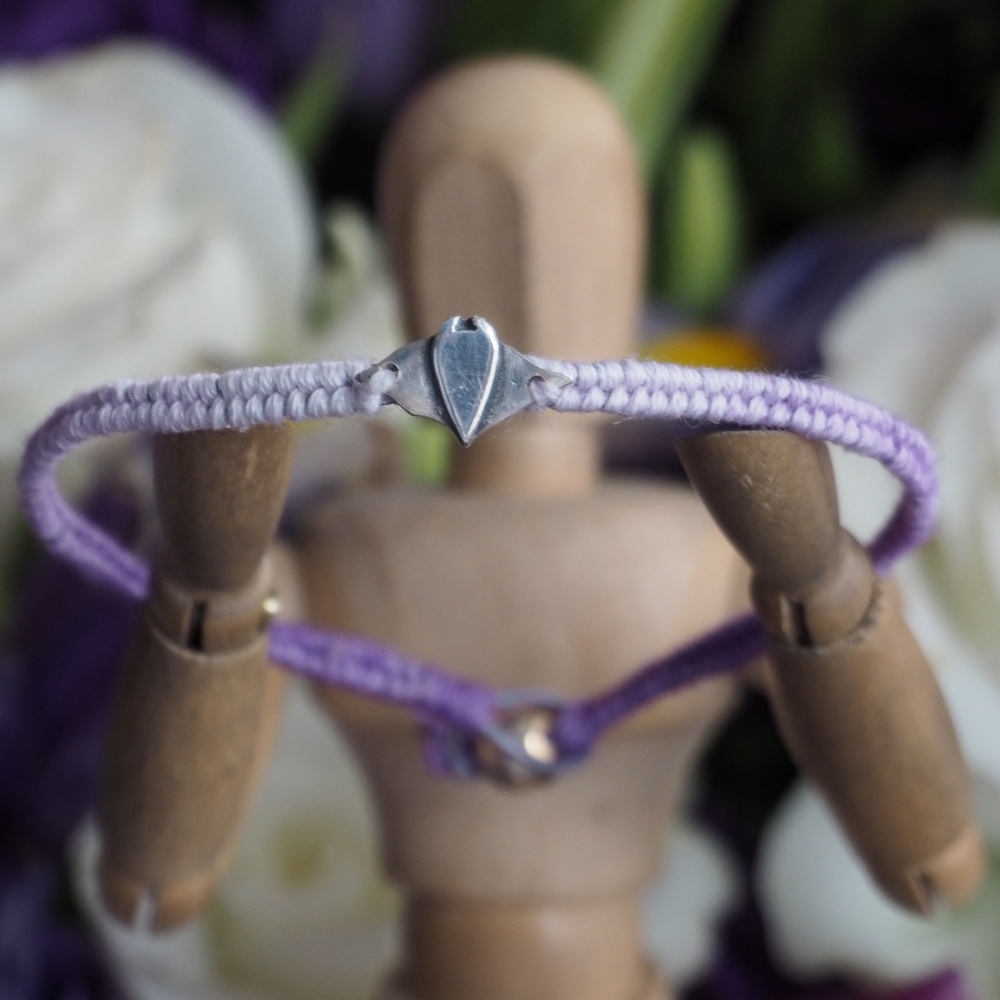 Fine silver manta ray charm on a purple friendship bracelet