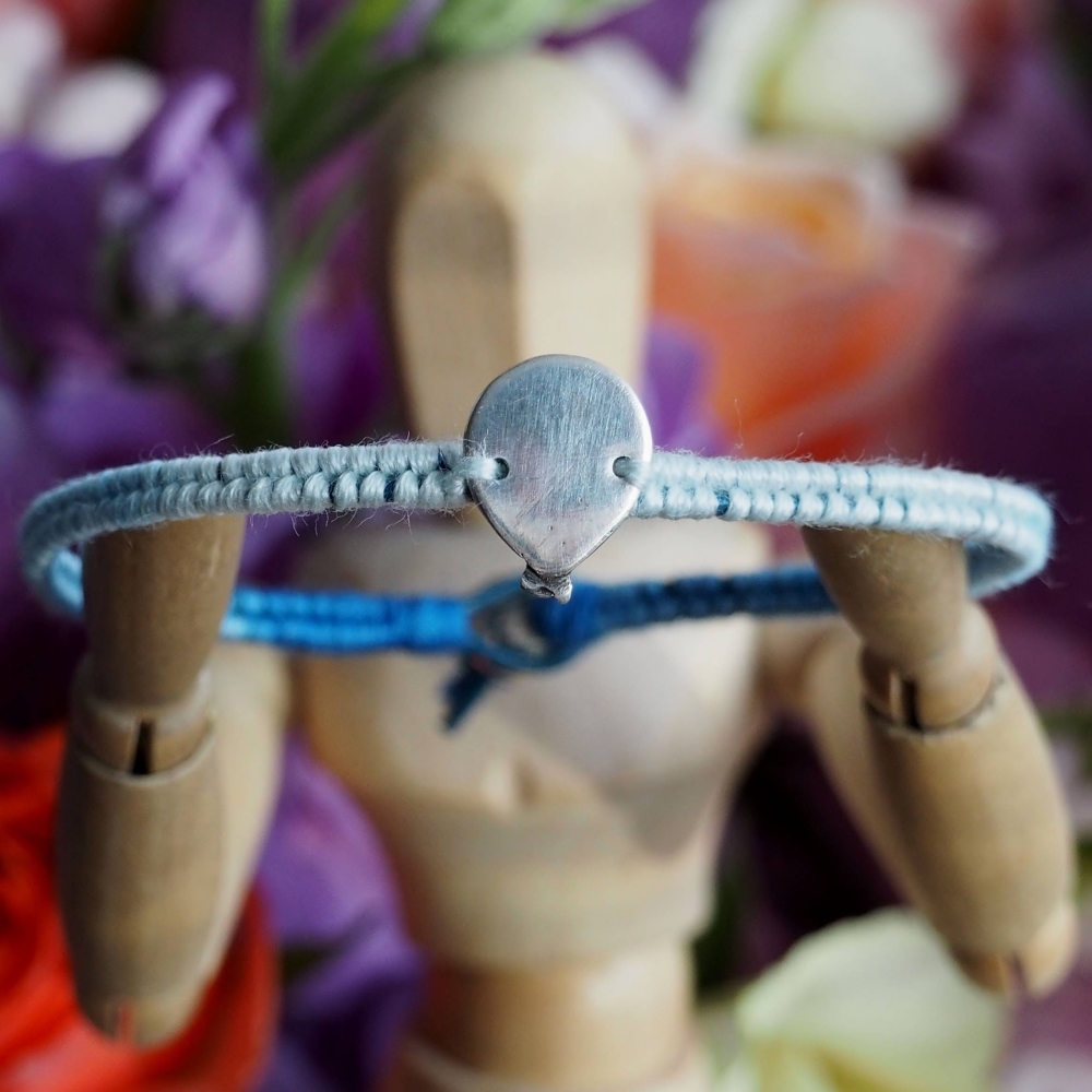 Fine silver balloon charm on a blue friendship bracelet