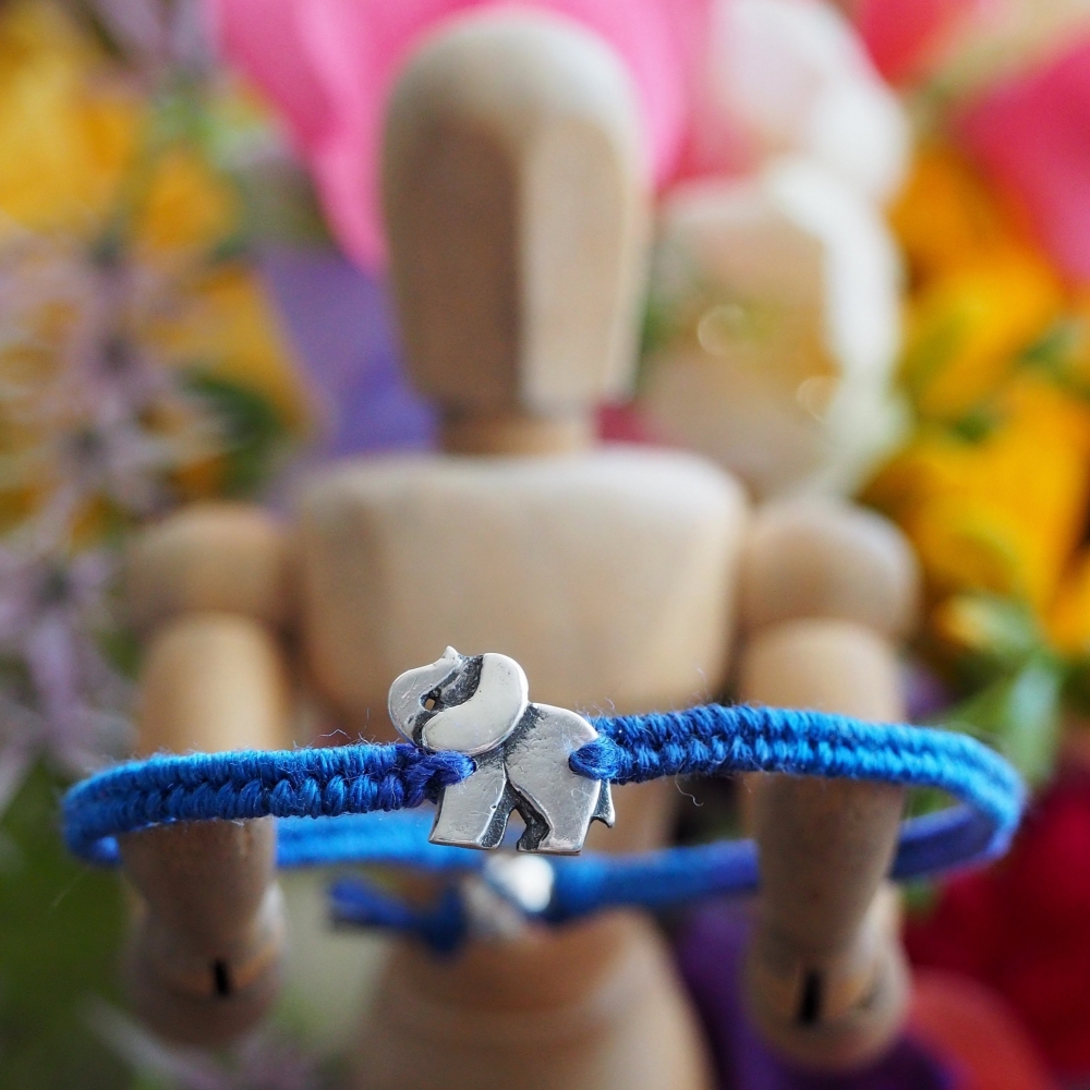Fine silver elephant charm on a blue friendship bracelet