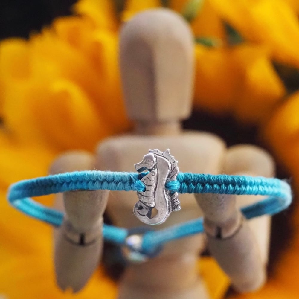 Fine silver seahorse charm on a turquoise/blue frindship bracelet