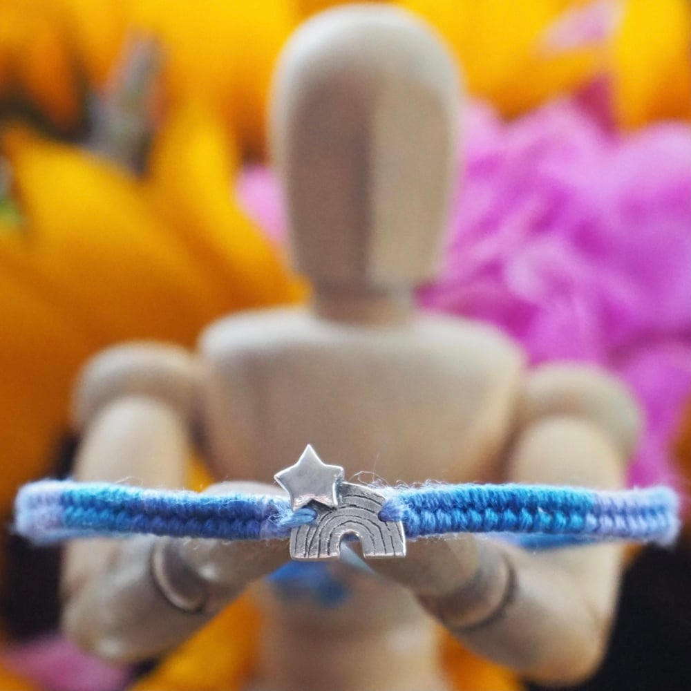 Fine silver rainbow and star charm on a lilac friendship bracelet